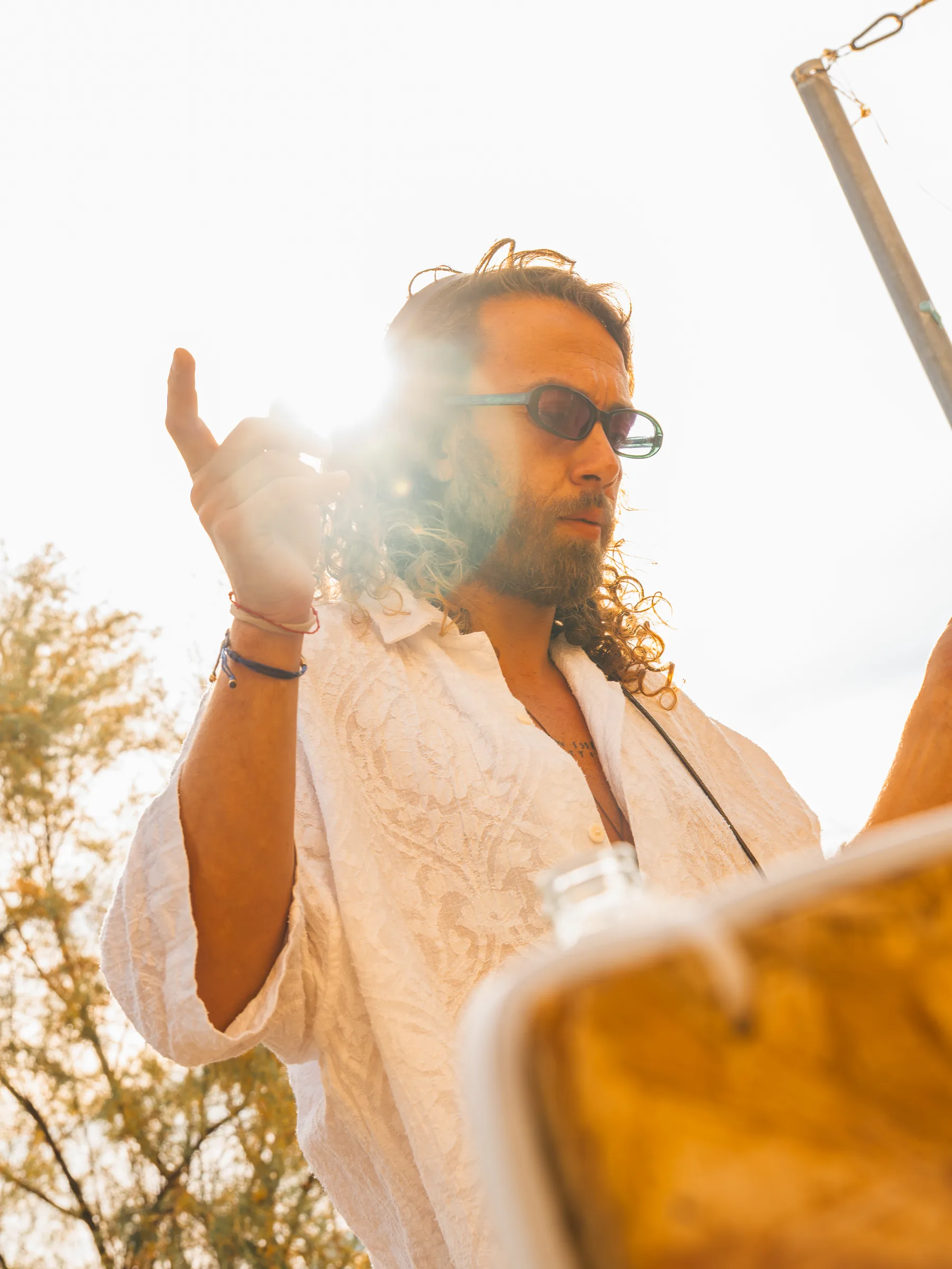 Ritratto in controluce di un dj di Lazy Buns con il sole fra le dita