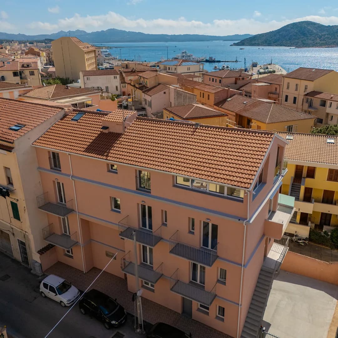 Il palazzo degli appartamenti ripreso dal drone, con il paese e il mare sullo sfondo